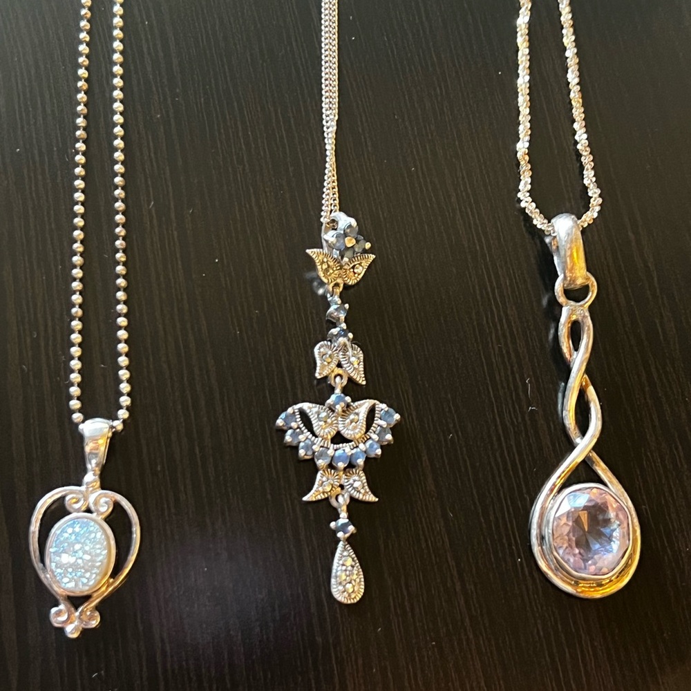 Sajen and other 2 sterling silver pendants with sterling silver chains as well.